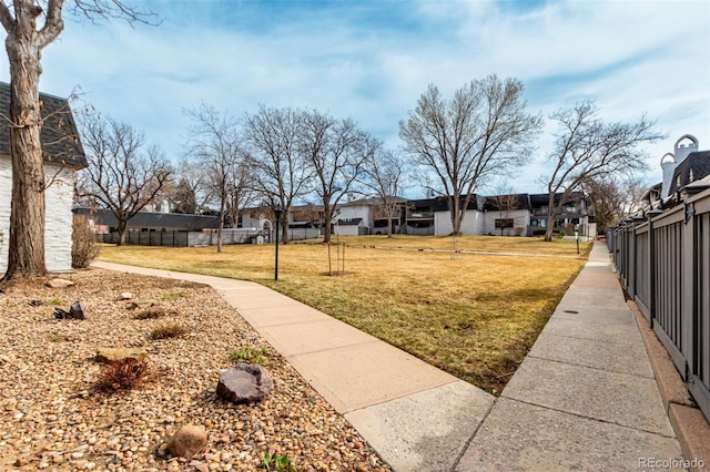 view of yard with a residential view and fence