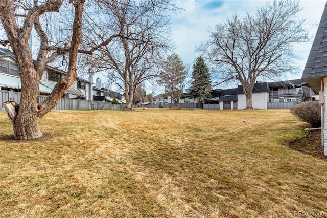 view of yard with fence and a residential view