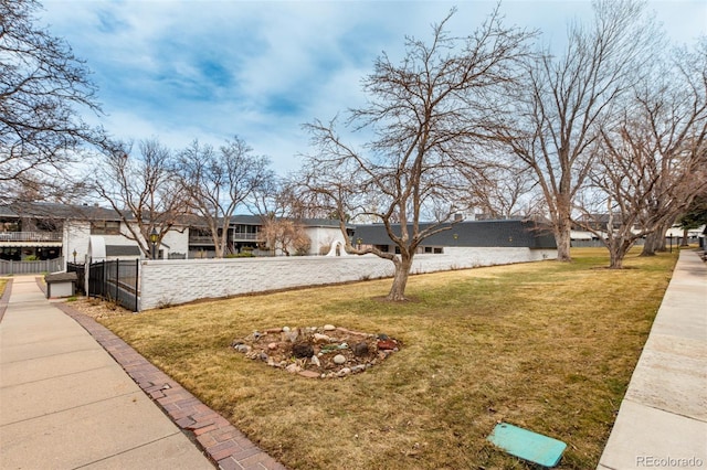 exterior space with a fenced front yard and a front lawn