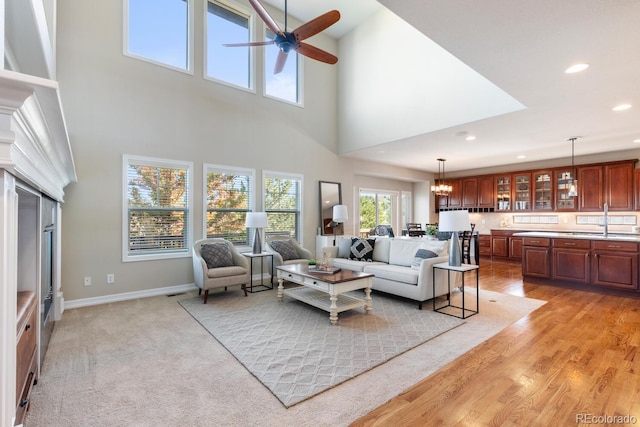 1519 Stonehill Ct, Castle Rock, CO 80104 - living area featuring a ceiling fan, recessed lighting, a towering ceiling, a fireplace, and baseboards