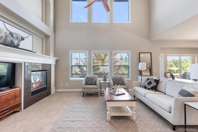 1519 Stonehill Ct, Castle Rock, CO 80104 - living room featuring plenty of natural light, carpet, a tile fireplace, a high ceiling, and a ceiling fan