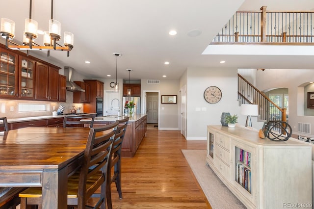1519 Stonehill Ct, Castle Rock, CO 80104 - dining area featuring light wood-type flooring, recessed lighting, a chandelier, arched walkways, and baseboards