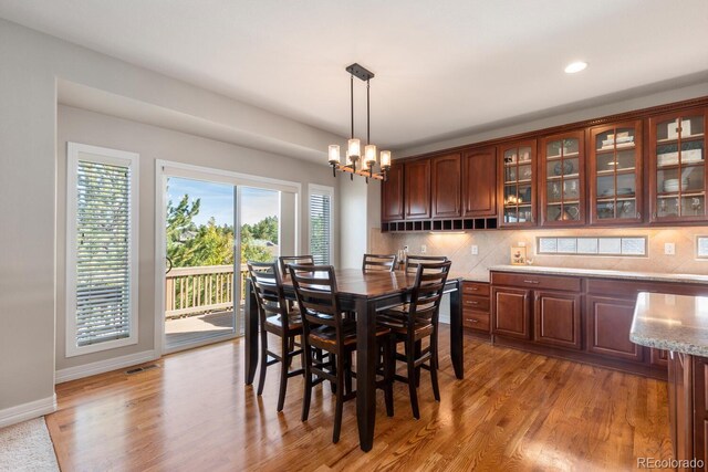 1519 Stonehill Ct, Castle Rock, CO 80104 - dining area with light wood-style flooring, baseboards, a chandelier, and recessed lighting