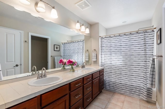 1519 Stonehill Ct, Castle Rock, CO 80104 - bathroom featuring double vanity, tile patterned flooring, and curtained shower