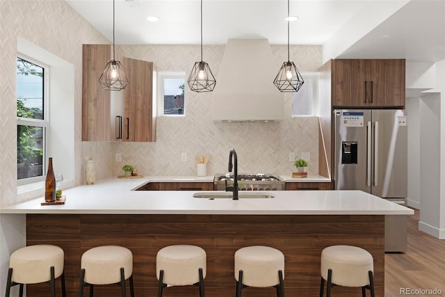 2849 N Vine St, Denver, CO 80205 - kitchen with modern cabinets, light countertops, a breakfast bar area, pendant lighting, and a peninsula
