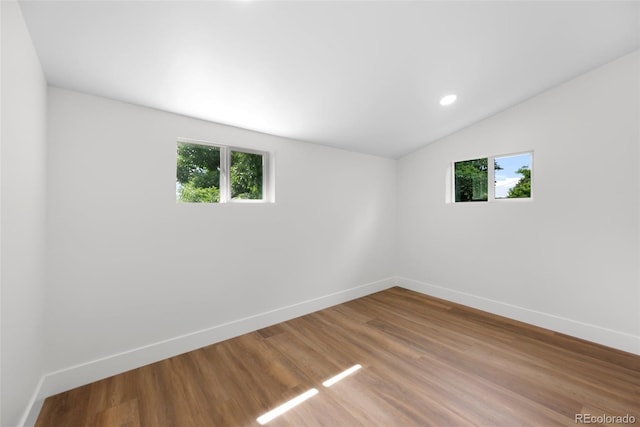 2849 N Vine St, Denver, CO 80205 - spare room with lofted ceiling, wood finished floors, and recessed lighting