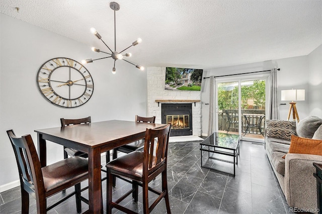9519 W Coal Mine Ave Unit F, Littleton, CO 80123 - dining room featuring a textured ceiling, a large fireplace, and a chandelier