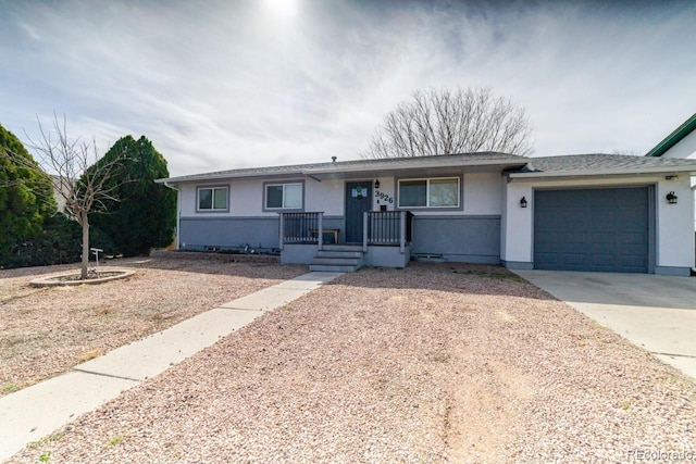 single story home featuring stucco siding, driveway, and a garage