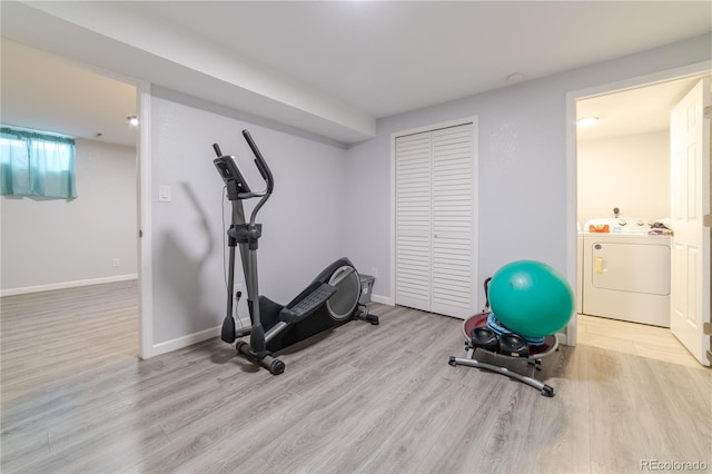 exercise area featuring washer / dryer, wood finished floors, and baseboards