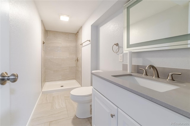 full bath featuring vanity, toilet, marble finish floor, and tiled shower