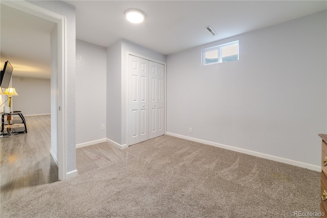 unfurnished bedroom featuring visible vents, baseboards, a closet, and carpet flooring