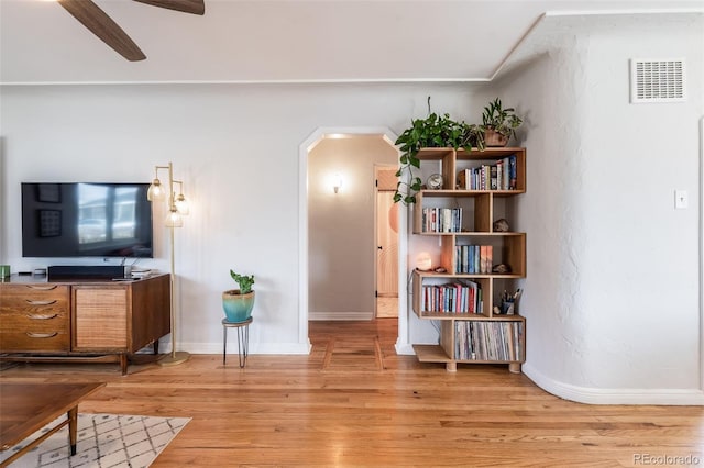430 Osceola St, Denver, CO 80204 - living area featuring arched walkways, light wood-type flooring, baseboards, and a ceiling fan