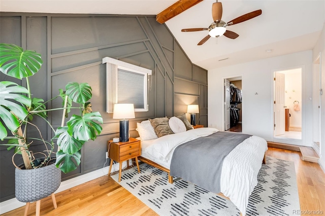 430 Osceola St, Denver, CO 80204 - bedroom featuring light wood-style floors, baseboards, a spacious closet, a decorative wall, and ceiling fan