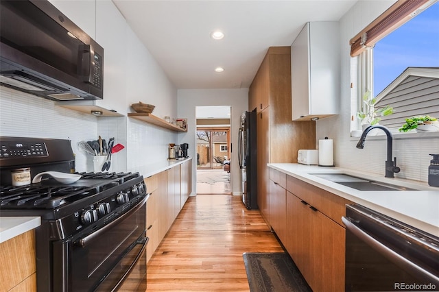 430 Osceola St, Denver, CO 80204 - kitchen featuring double oven range, dishwasher, a sink, freestanding refrigerator, and light countertops
