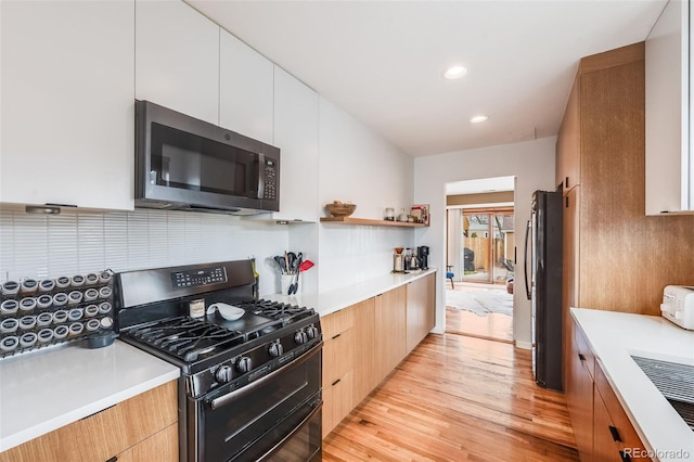 430 Osceola St, Denver, CO 80204 - kitchen with black appliances, modern cabinets, tasteful backsplash, light countertops, and recessed lighting