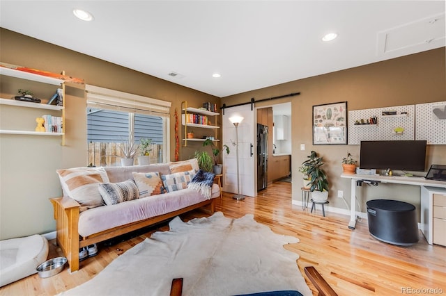 430 Osceola St, Denver, CO 80204 - living room featuring a barn door, wood finished floors, and recessed lighting