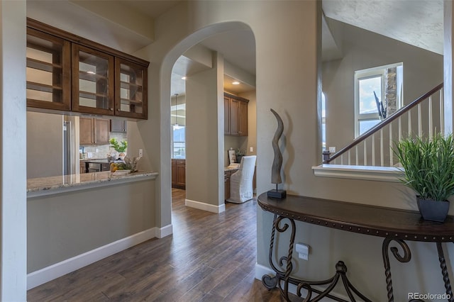 3012 Cathedral Park Vw, Colorado Springs, CO 80904 - interior space with dark wood-style flooring, arched walkways, and stairway