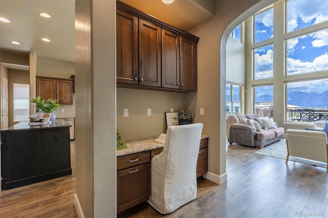 3012 Cathedral Park Vw, Colorado Springs, CO 80904 - kitchen with dark wood-style floors, light stone countertops, recessed lighting, and open floor plan