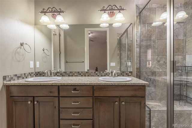3012 Cathedral Park Vw, Colorado Springs, CO 80904 - full bath with a stall shower, double vanity, and backsplash