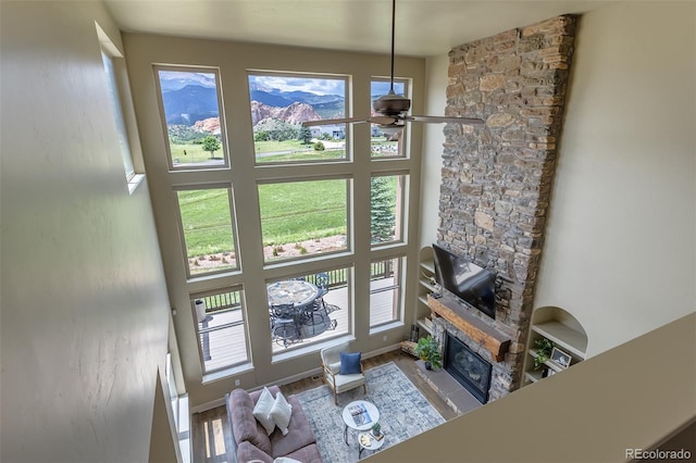 3012 Cathedral Park Vw, Colorado Springs, CO 80904 - living room with a ceiling fan, a stone fireplace, and wood finished floors