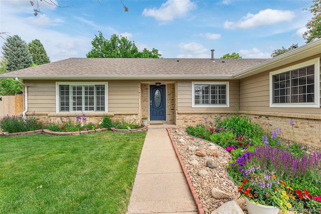 7719 S Jackson Cir, Centennial, CO 80122 - ranch-style home featuring brick siding, a front yard, and a shingled roof