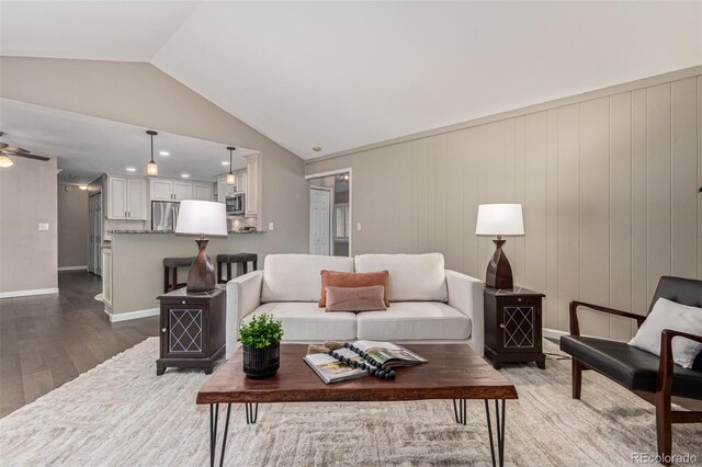 7719 S Jackson Cir, Centennial, CO 80122 - living room featuring dark wood-style floors, vaulted ceiling, and a ceiling fan