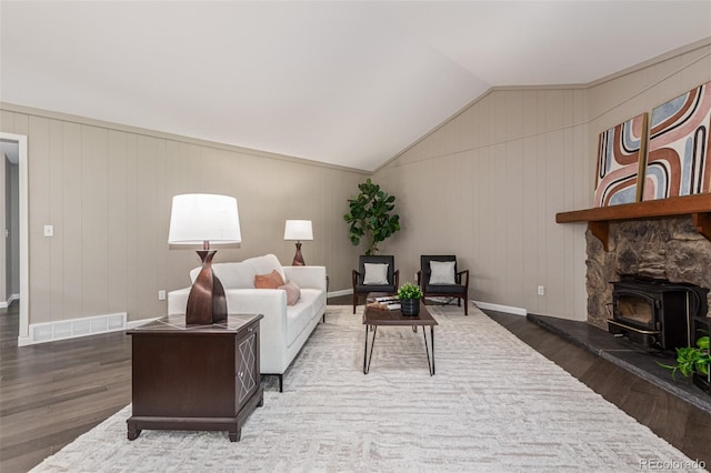 7719 S Jackson Cir, Centennial, CO 80122 - living area featuring wood finished floors, a wood stove, and lofted ceiling