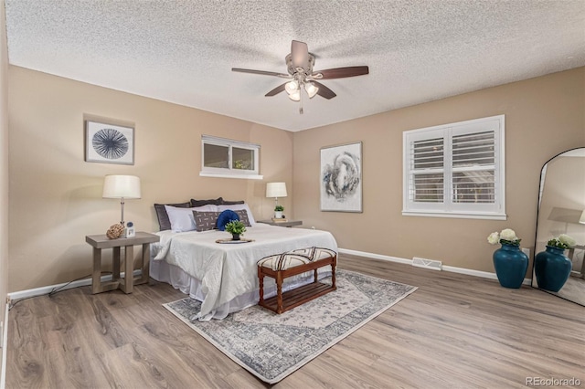 7719 S Jackson Cir, Centennial, CO 80122 - bedroom featuring wood finished floors, a textured ceiling, and a ceiling fan