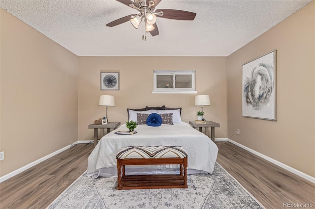 7719 S Jackson Cir, Centennial, CO 80122 - bedroom featuring wood finished floors, a textured ceiling, and a ceiling fan