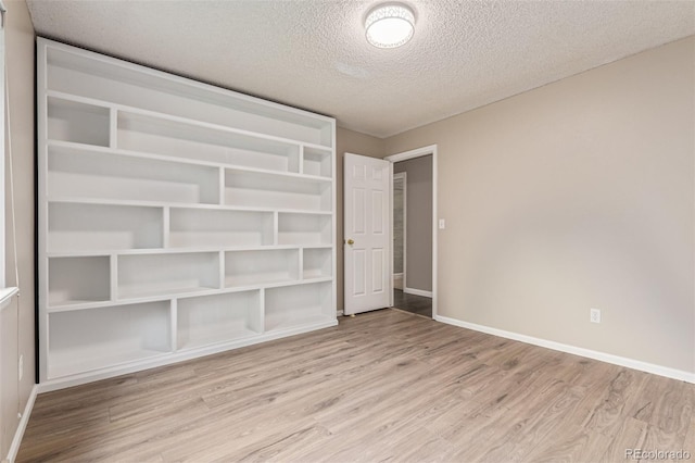 7719 S Jackson Cir, Centennial, CO 80122 - unfurnished bedroom with wood finished floors and a textured ceiling