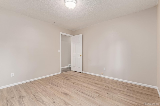 7719 S Jackson Cir, Centennial, CO 80122 - empty room with light wood-style flooring and a textured ceiling
