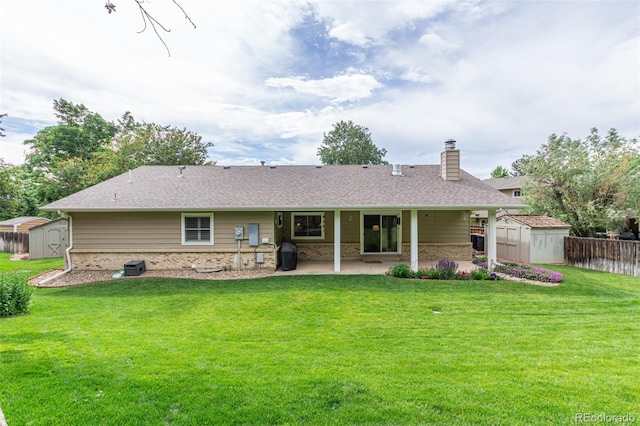 7719 S Jackson Cir, Centennial, CO 80122 - back of house with a storage shed, a patio area, a chimney, and brick siding