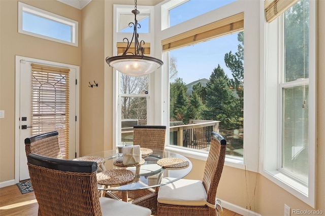 8528 Winter Berry Dr, Castle Pines, CO 80108 - dining space featuring baseboards, wood finished floors, and a towering ceiling