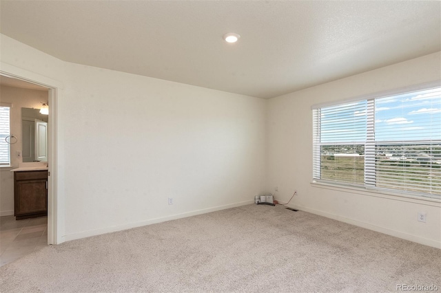 carpeted spare room with a wealth of natural light