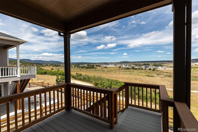 wooden deck with a mountain view and a rural view