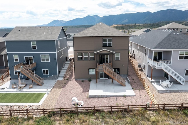 back of house featuring a mountain view and a patio