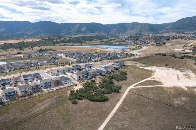 birds eye view of property featuring a water and mountain view