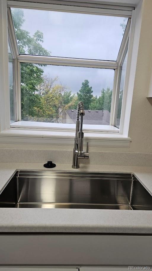 18531 E Tanforan Pl, Aurora, CO 80015 - kitchen view of a sink and light countertops