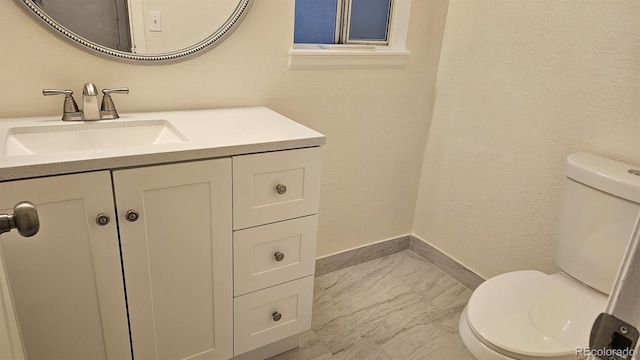 18531 E Tanforan Pl, Aurora, CO 80015 - bathroom with toilet, vanity, baseboards, and marble finish floors