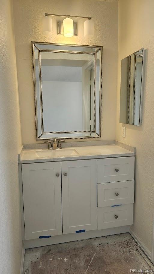 18531 E Tanforan Pl, Aurora, CO 80015 - bathroom featuring vanity, baseboards, and a textured wall