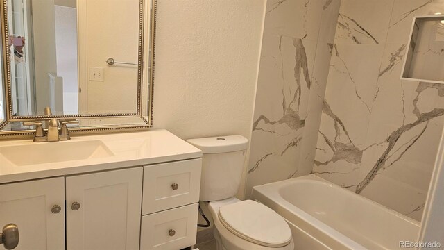 18531 E Tanforan Pl, Aurora, CO 80015 - full bath featuring toilet, vanity, a textured wall, and shower / bath combination