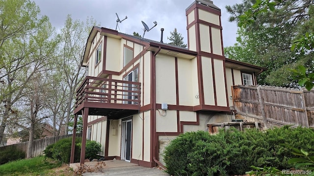 18531 E Tanforan Pl, Aurora, CO 80015 - back of property with a deck, a garage, a chimney, and stucco siding