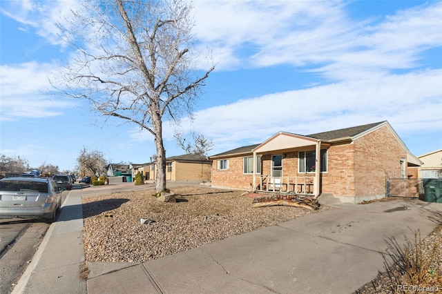 ranch-style house featuring brick siding