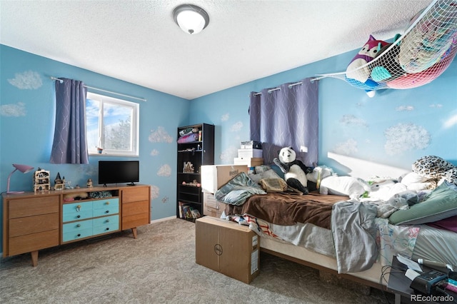 bedroom with carpet floors and a textured ceiling