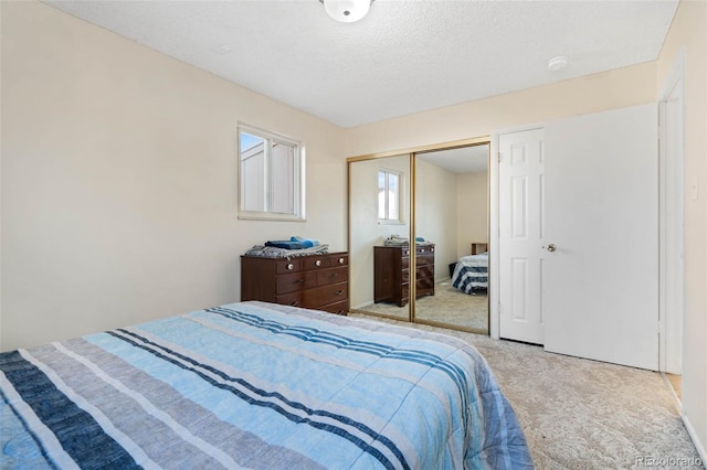 bedroom featuring a closet, carpet, and a textured ceiling