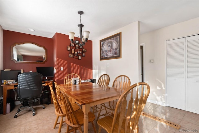 dining space featuring light tile patterned flooring and a chandelier