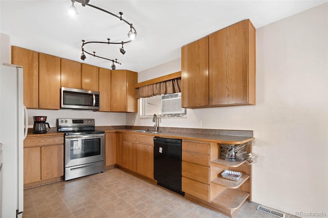 kitchen with visible vents, a sink, stainless steel appliances, dark countertops, and brown cabinets