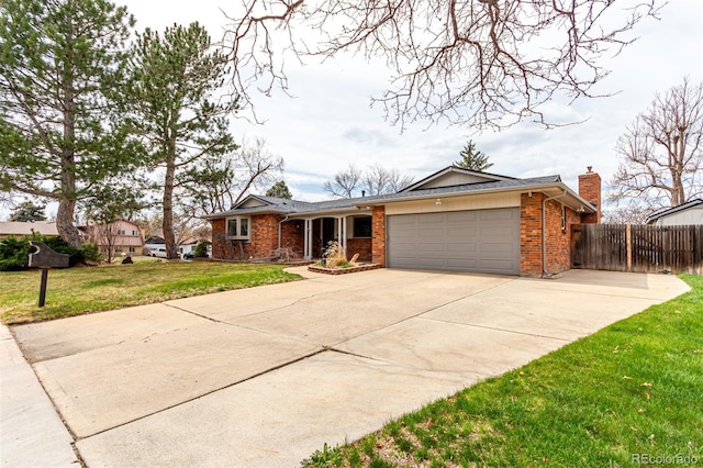 699 S Oswego St, Aurora, CO 80012 - single story home featuring a garage, brick siding, driveway, and a chimney