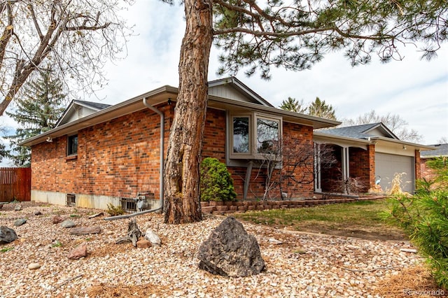 699 S Oswego St, Aurora, CO 80012 - view of front of property featuring brick siding and a garage