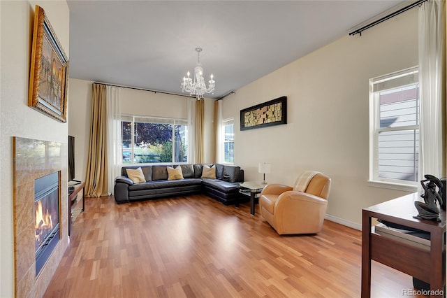 living room with wood-type flooring and an inviting chandelier